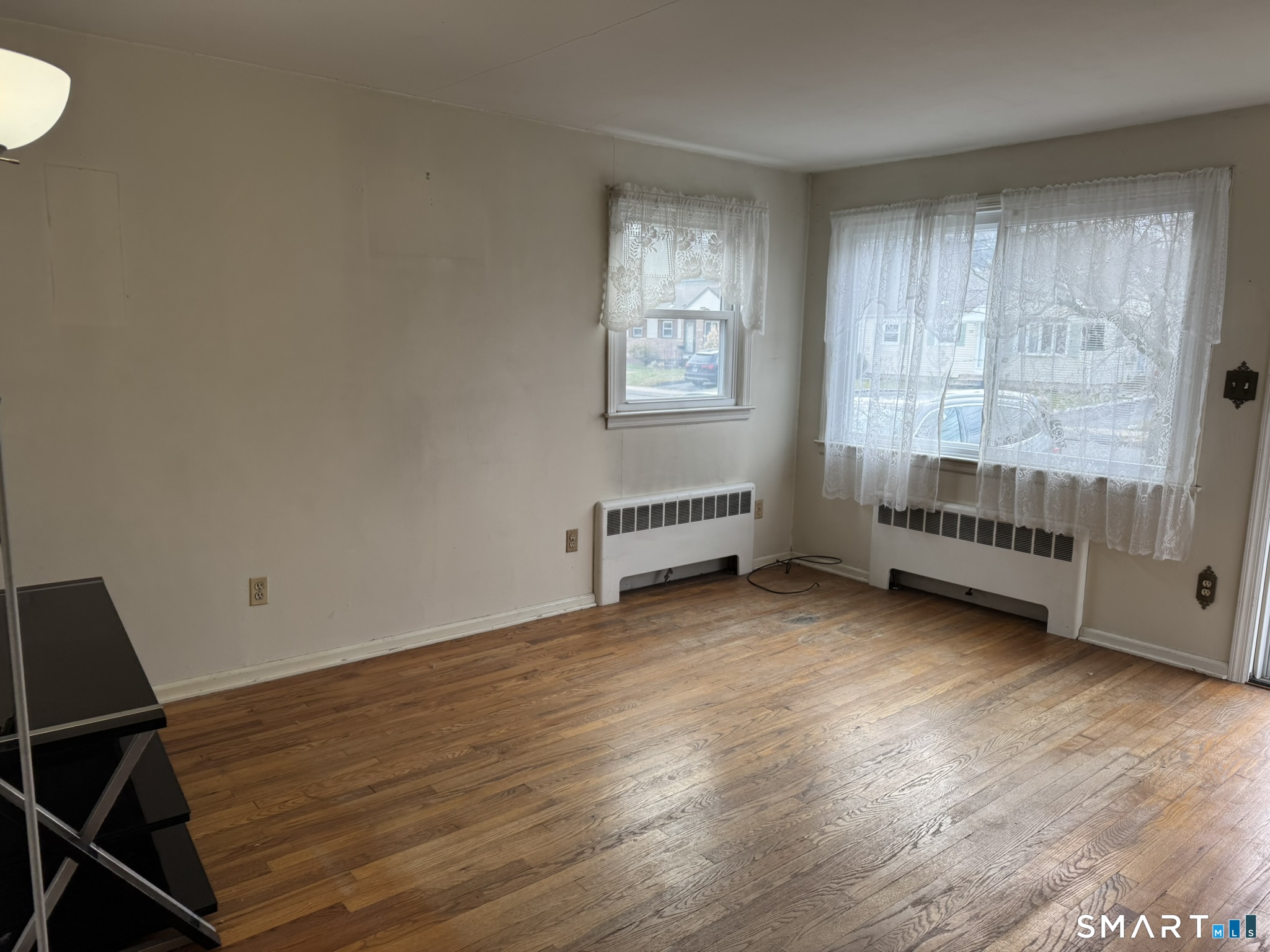 111 Harvard Street Hartford, CT 06106 - Photo 19 of 21 an empty room with wooden floor and windows