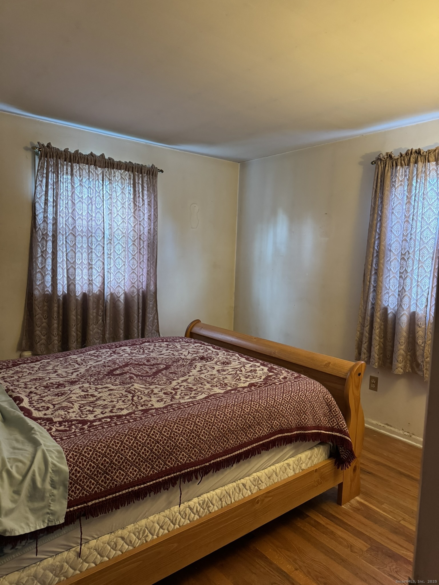 111 Harvard Street Hartford, CT 06106 - Photo 5 of 21 a bedroom with a bed and a mirror