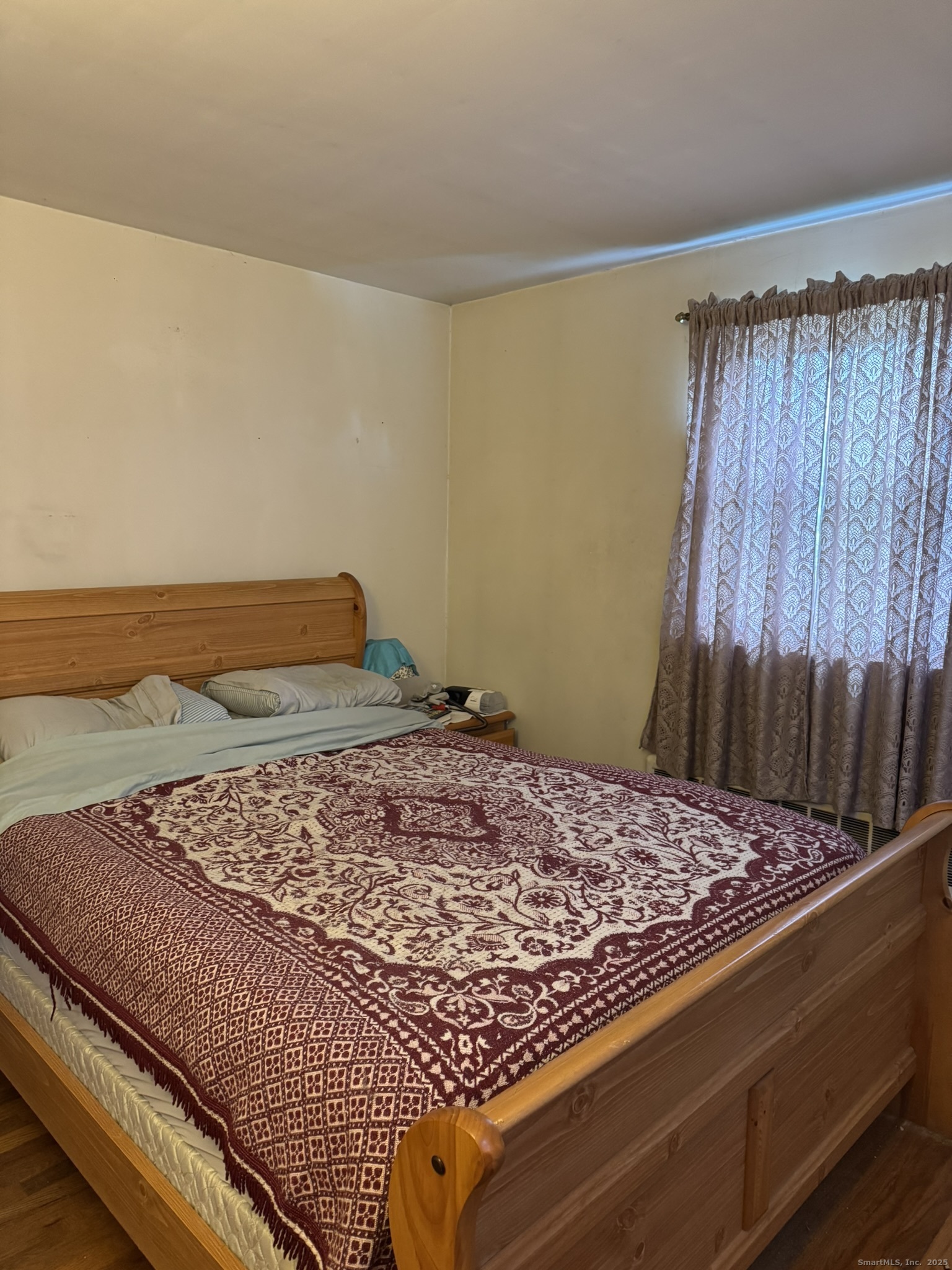 111 Harvard Street Hartford, CT 06106 - Photo 6 of 21 a bed sitting in a bedroom next to a larger window