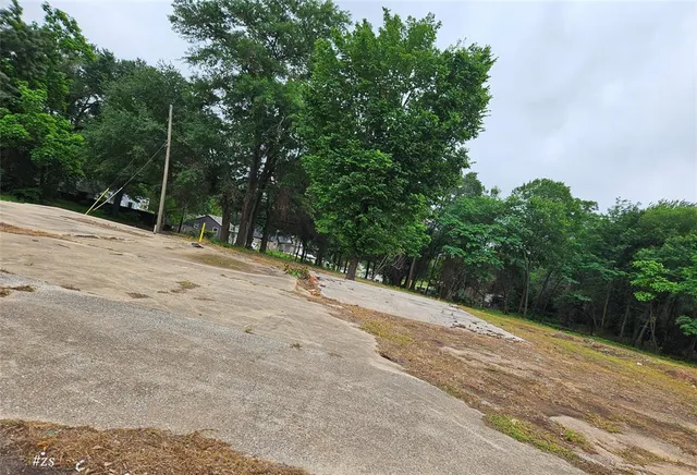 a wooden bench with view of trees