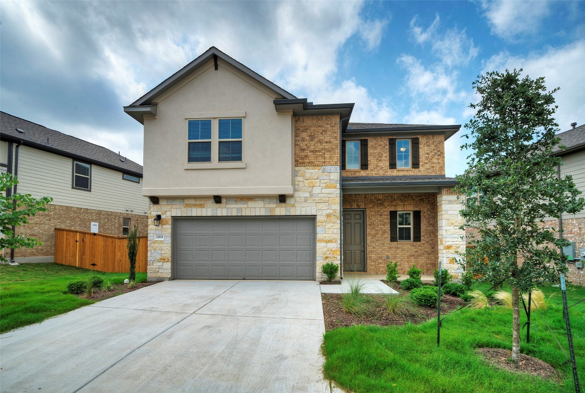 a front view of house with yard and green space