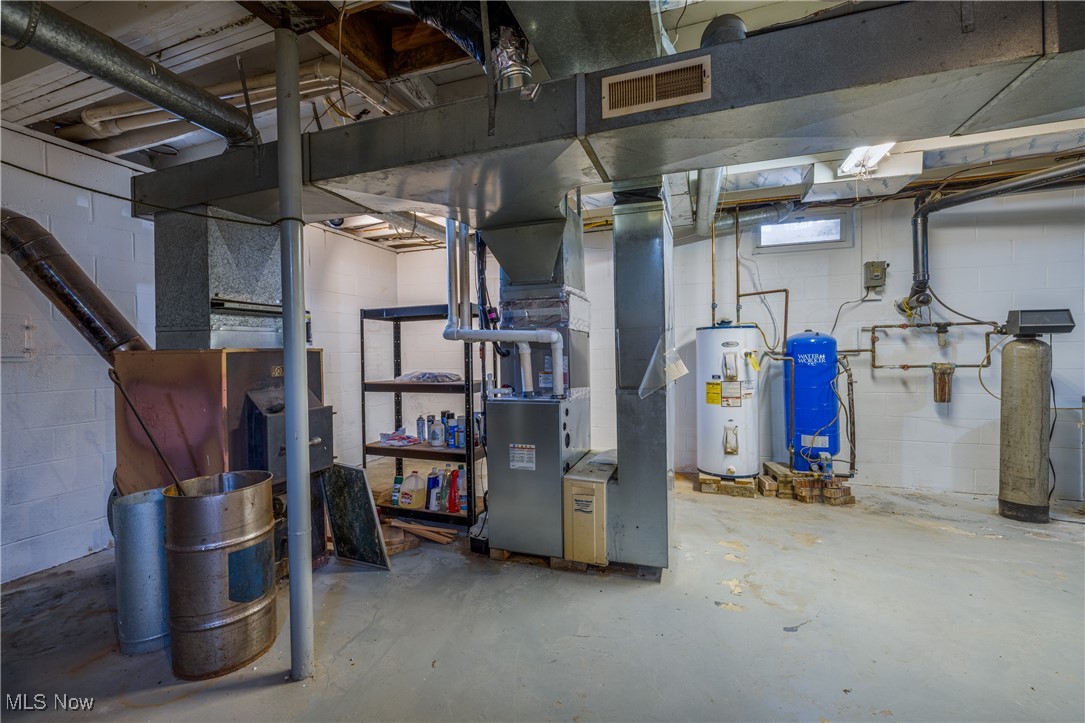 24534 Mill Road Utica, OH 43080 - Photo 25 of 38 Basement with a water pressure tank, electric water heater, a water softener, and heating unit