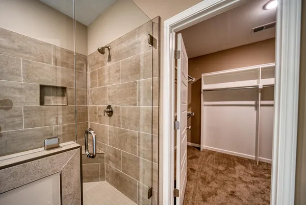 a bathroom with a shower and a sink