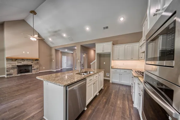 a kitchen with a stove sink and a microwave
