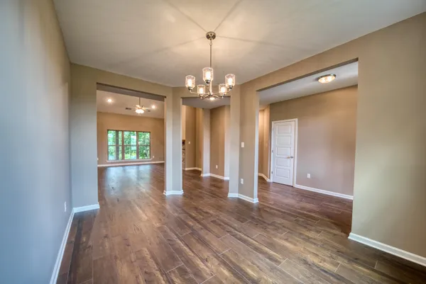 a view of a livingroom with wooden floor and chandelier
