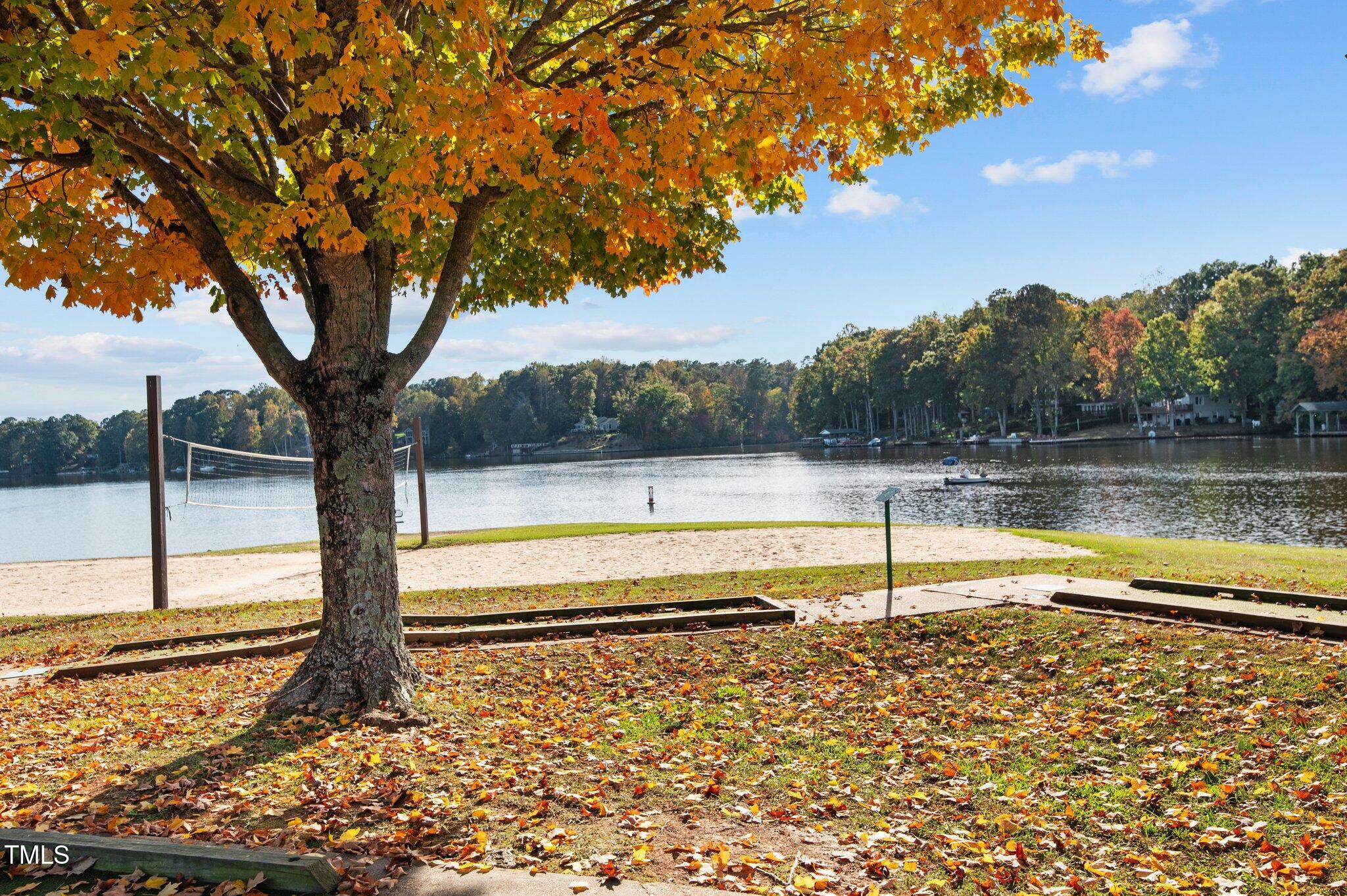 123 Catoose Drive Spring Hope, NC 27882 - Photo 19 of 38 a view of a lake with a yard and large trees