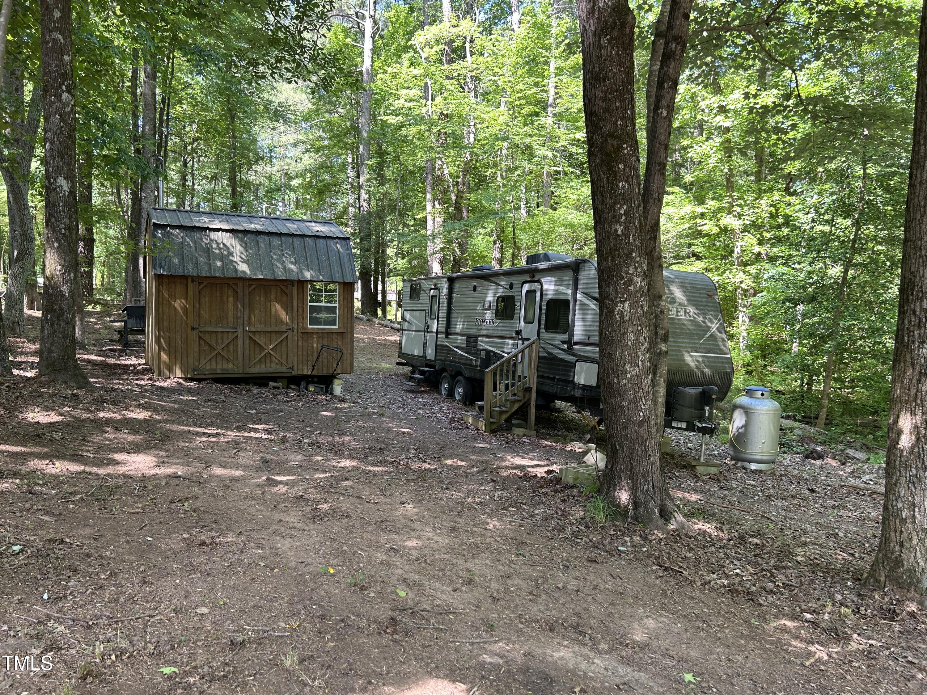 123 Catoose Drive Spring Hope, NC 27882 - Photo 4 of 38 a view of house and trees in the back yard