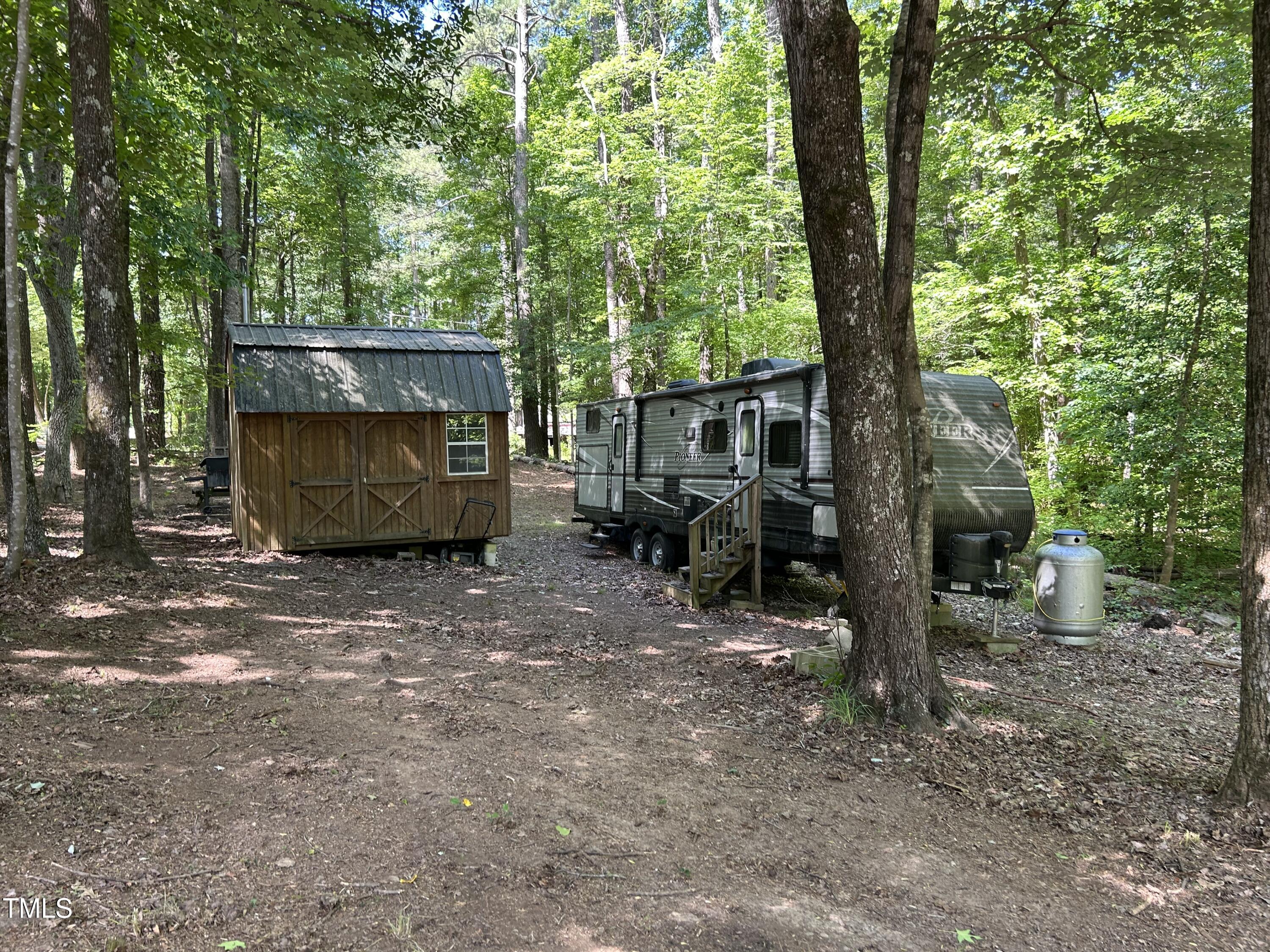 123 Catoose Drive Spring Hope, NC 27882 - Photo 5 of 38 a view of a barn in the middle of a yard