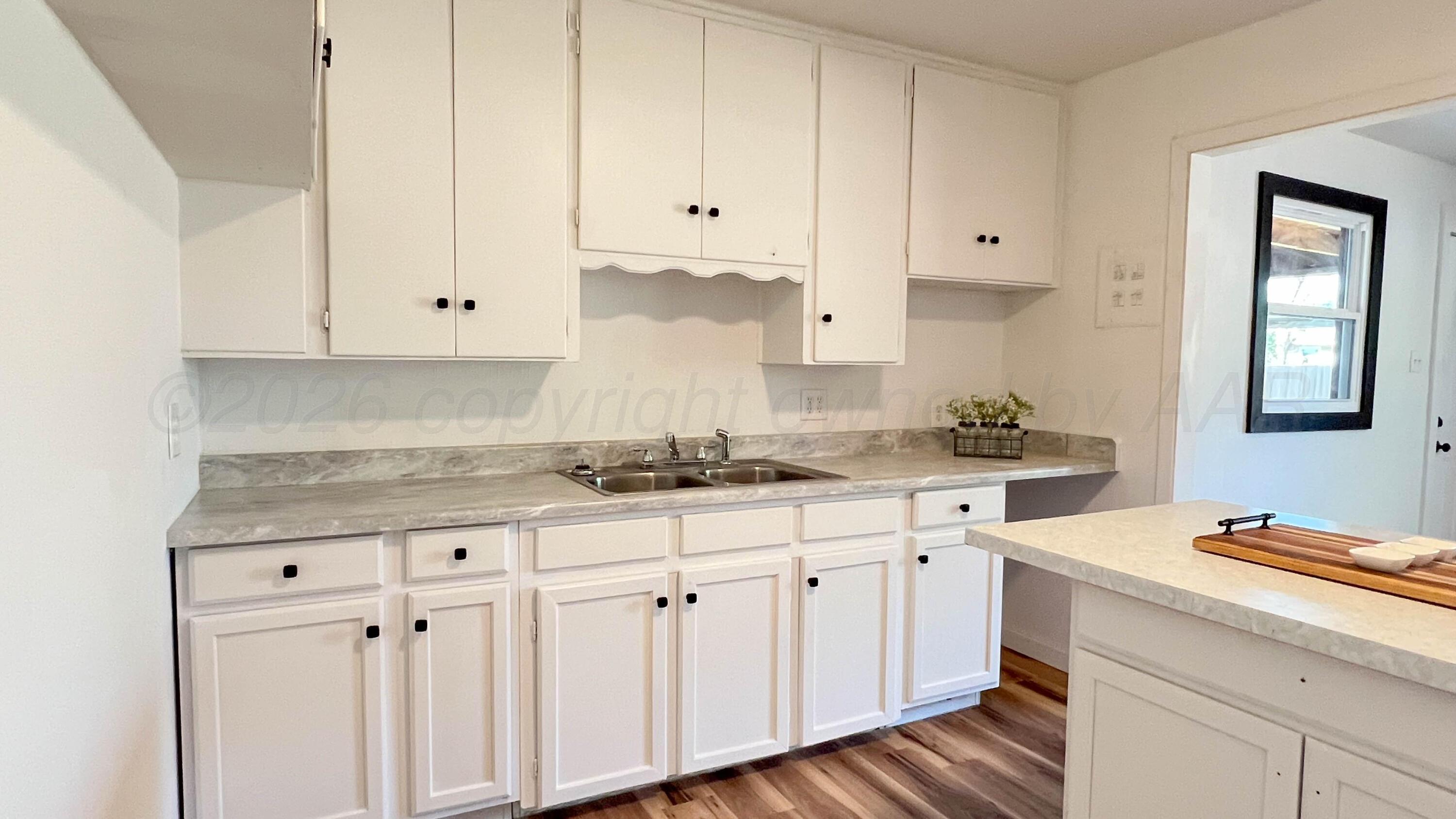 4410 South Ong Street Amarillo, TX 79110 - Photo 9 of 22 a kitchen with granite countertop white cabinets and white appliances
