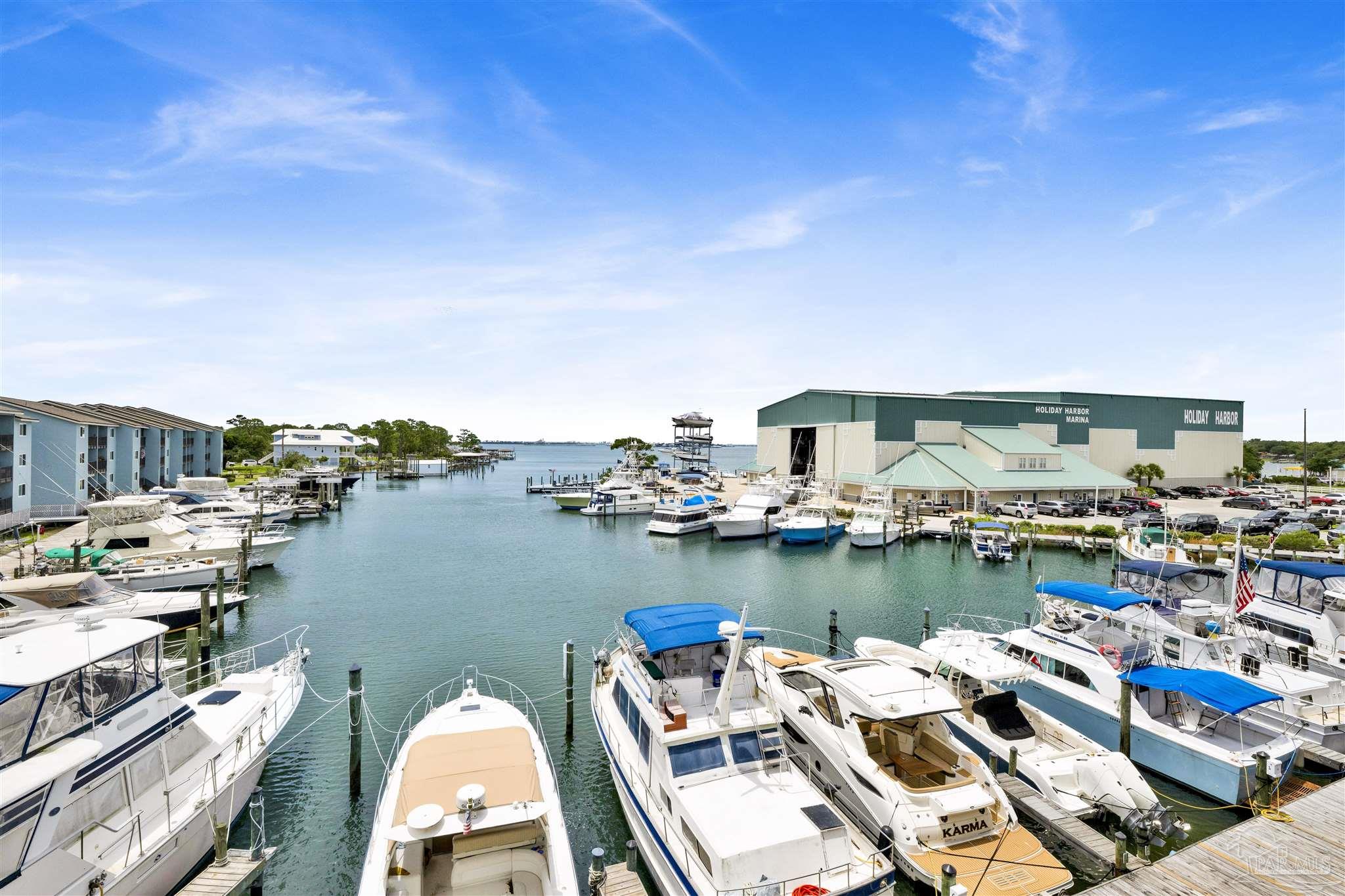 14100 River Road, Unit 334 Perdido Key, FL 32507 - Photo 6 of 35 a view of a lake with boats and trees in the background