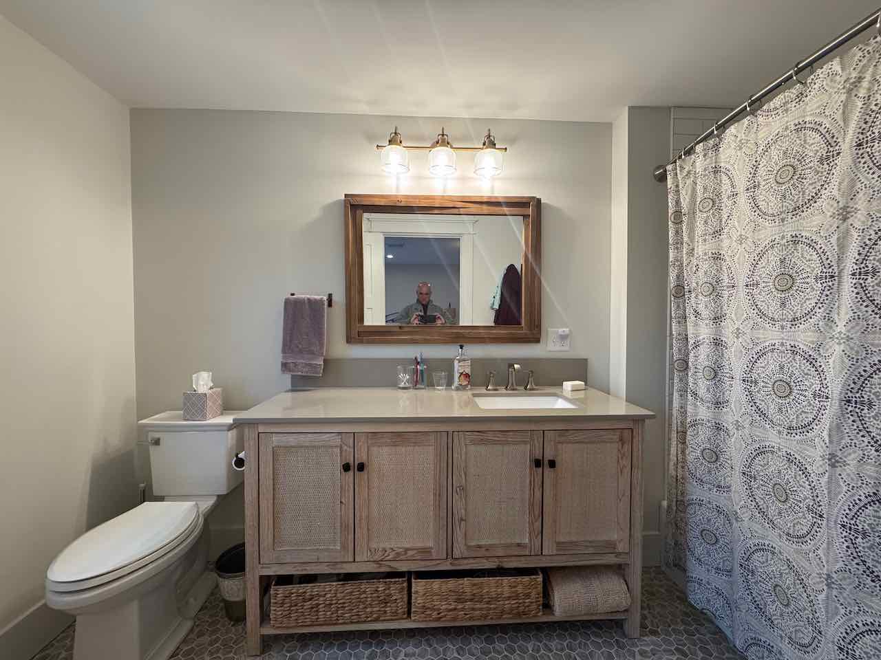 60 Meetinghouse Road Chilmark, MA 02535 - Photo 45 of 49 a bathroom with a granite countertop toilet a sink and a mirror