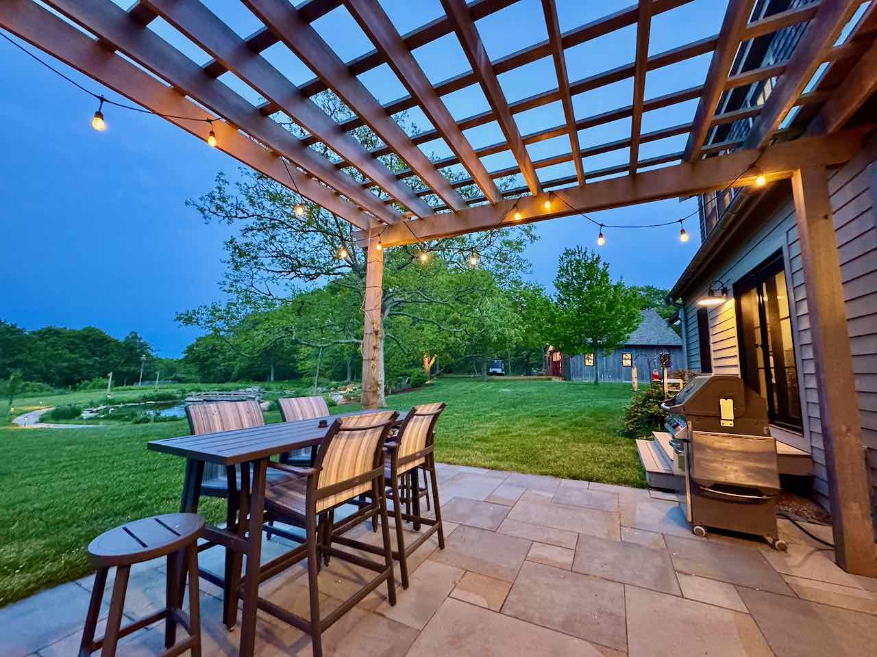 60 Meetinghouse Road Chilmark, MA 02535 - Photo 10 of 49 a view of a porch with furniture and a yard