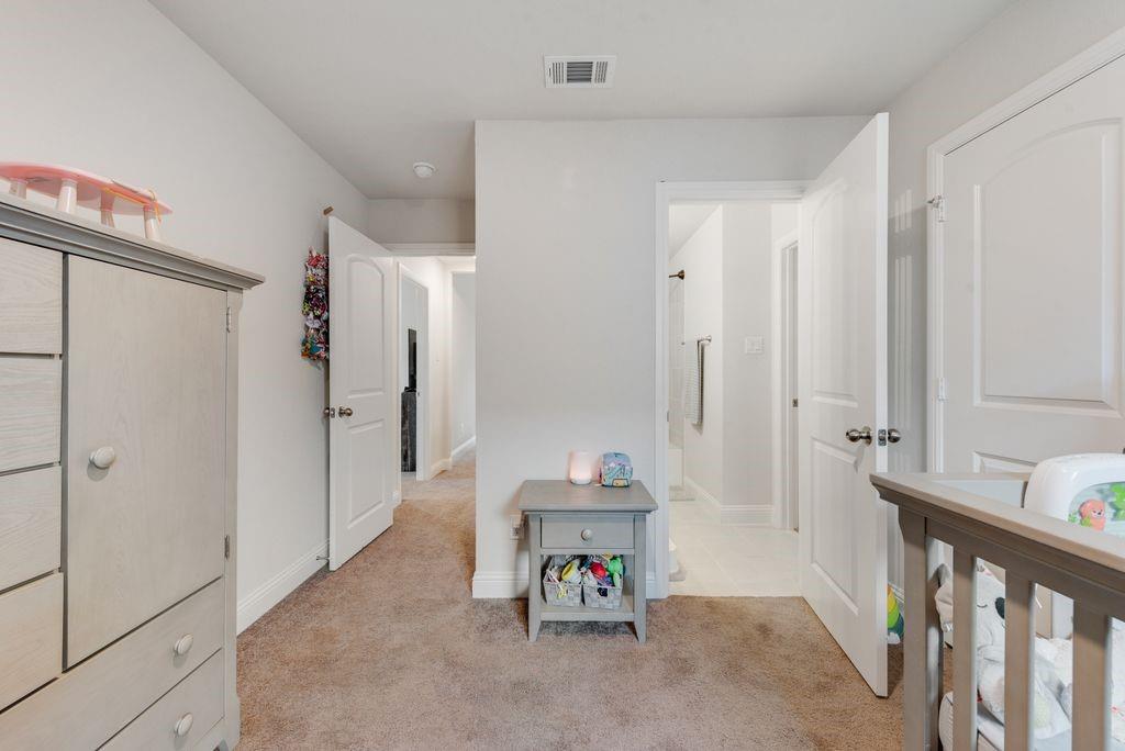 1202 Holly Street Cleburne, TX 76033 - Photo 28 of 36 a spacious bathroom with a tub shower and a sink