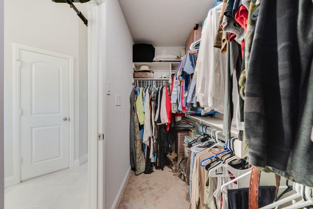 1202 Holly Street Cleburne, TX 76033 - Photo 31 of 36 a view of walk in closet with clothes