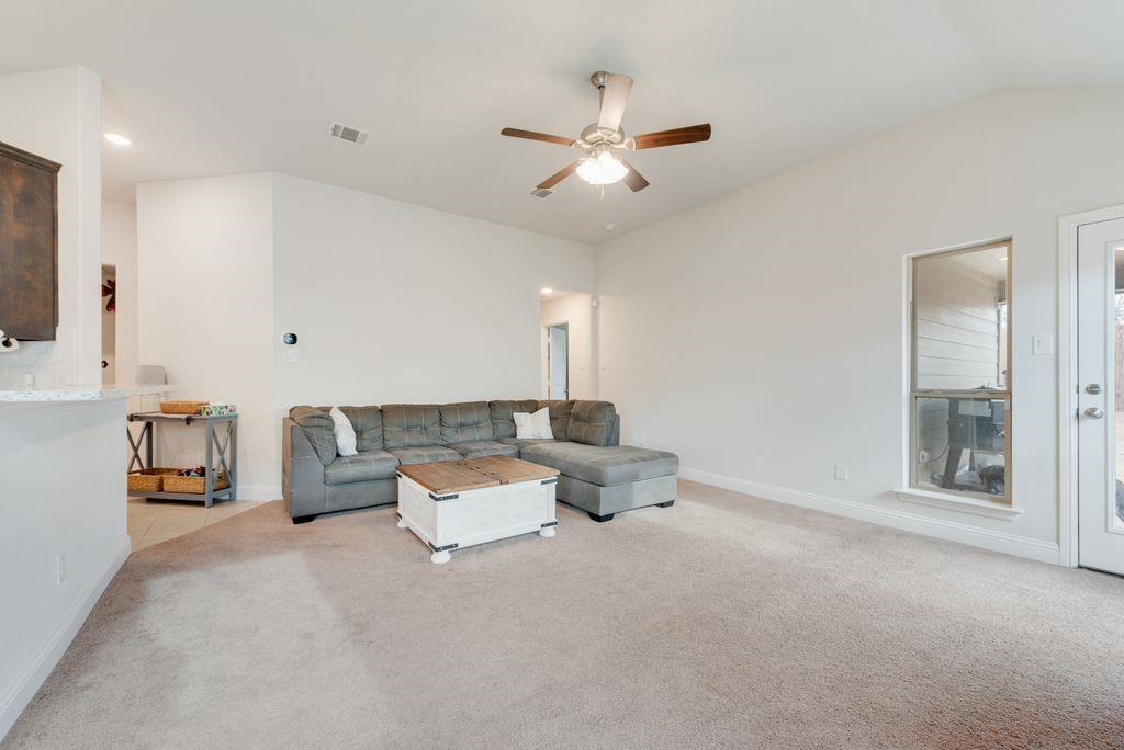 1202 Holly Street Cleburne, TX 76033 - Photo 7 of 36 a living room with furniture and a chandelier