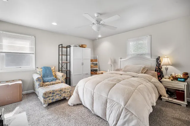 a bathroom with a granite countertop toilet sink and mirror