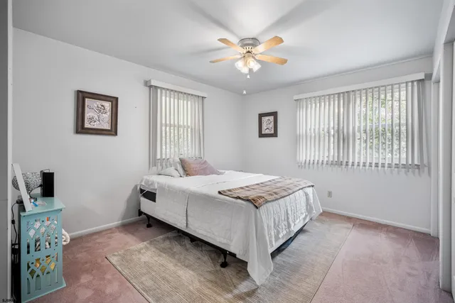 a bedroom with a bed and a flat tv screen