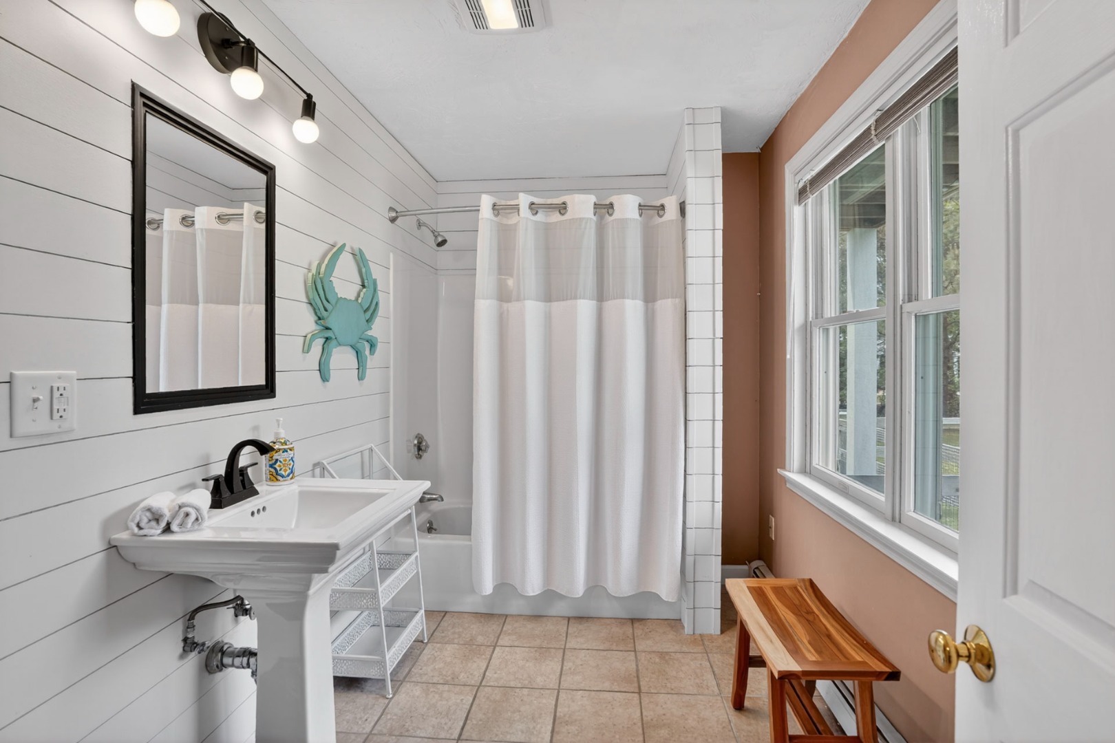 9 Thaxter Lane Edgartown, MA 02539 - Photo 39 of 53 a bathroom with a sink a mirror and a shower
