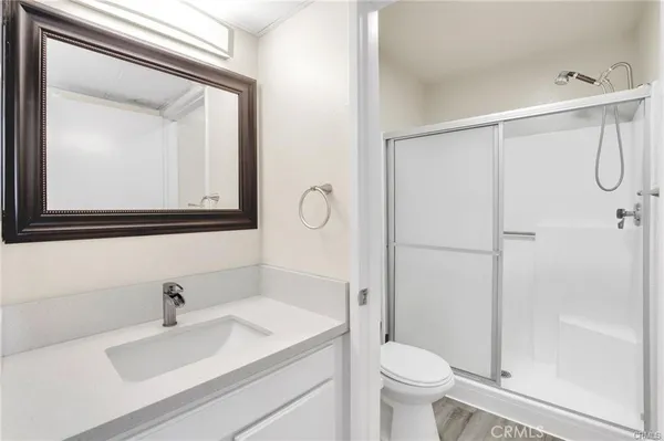 a bathroom with a sink vanity mirror and toilet