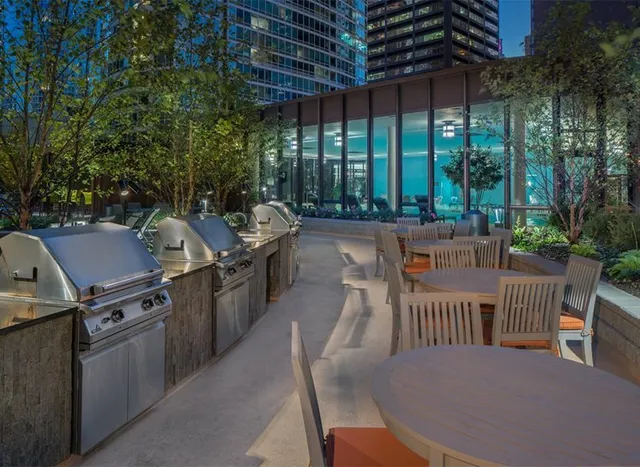 a view of a patio with a dining table and chairs with a wooden floor