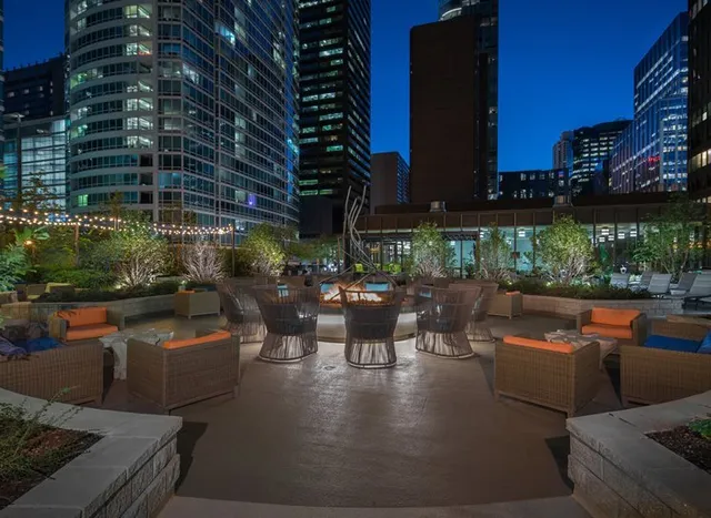 a view of a tennis court with chairs