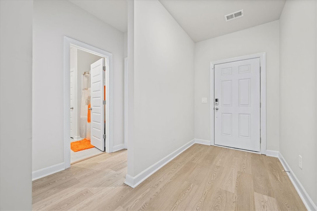 106 Purcell Way Easley, SC 29642 - Photo 26 of 39 This bright hallway offers easy access to a full bathroom and welcomes you home with durable flooring.