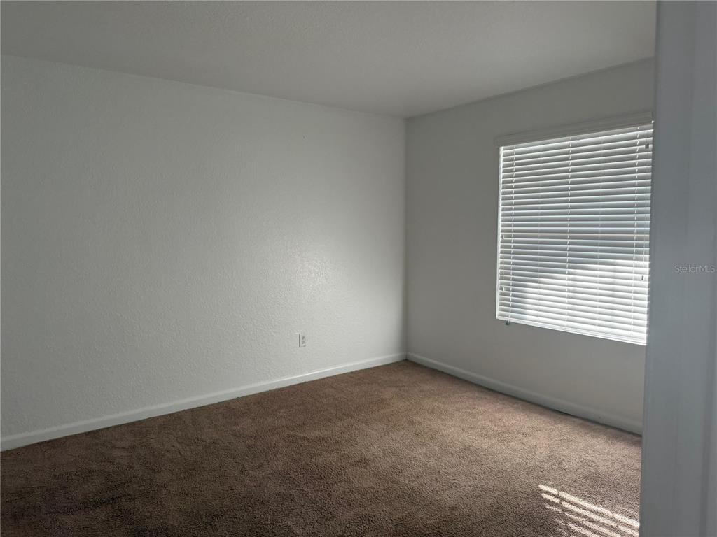 2323 McCoy Road, Unit 816 Orlando, FL 32809 - Photo 5 of 8 a view of an empty room with a window