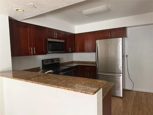 a bathroom with a granite countertop toilet sink and shower