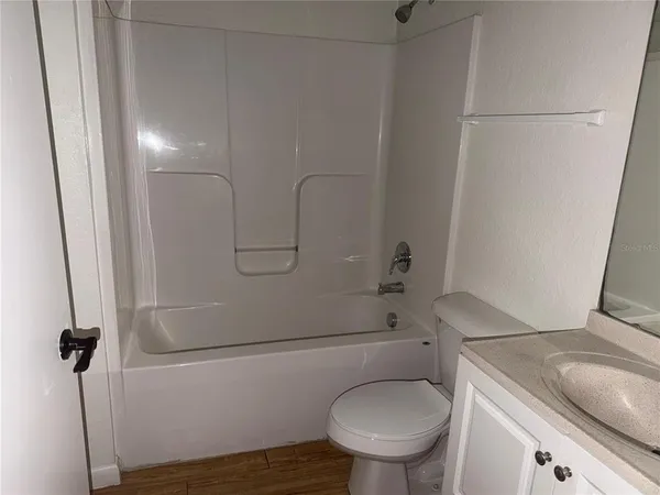 a view of a hallway with wooden floor and a hallway