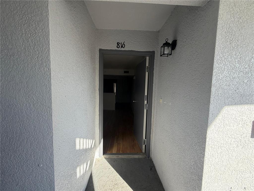 2323 McCoy Road, Unit 816 Orlando, FL 32809 - Photo 8 of 8 a view of a hallway with wooden floor and a hallway
