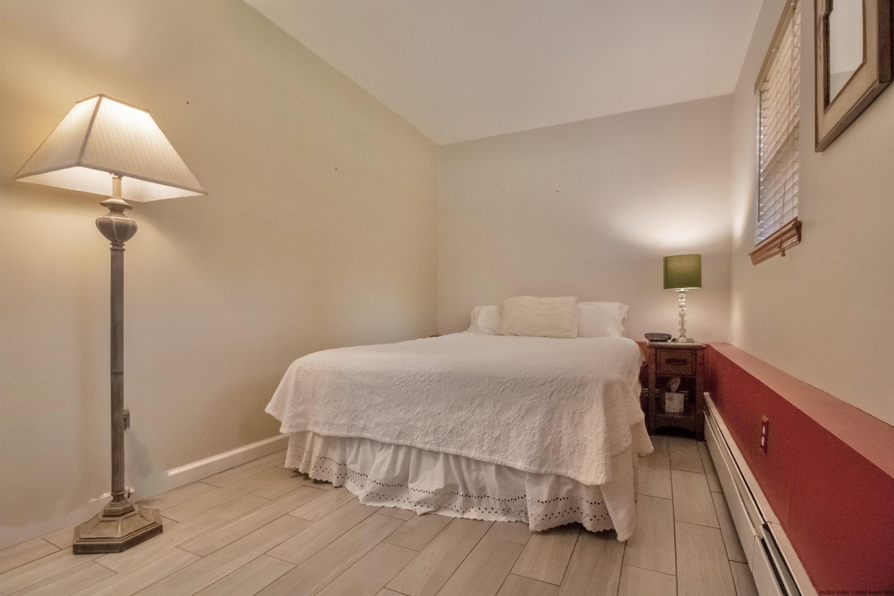 56 Alan Street Stone Ridge, NY 12484 - Photo 13 of 21 a bedroom with a bed and a lamp