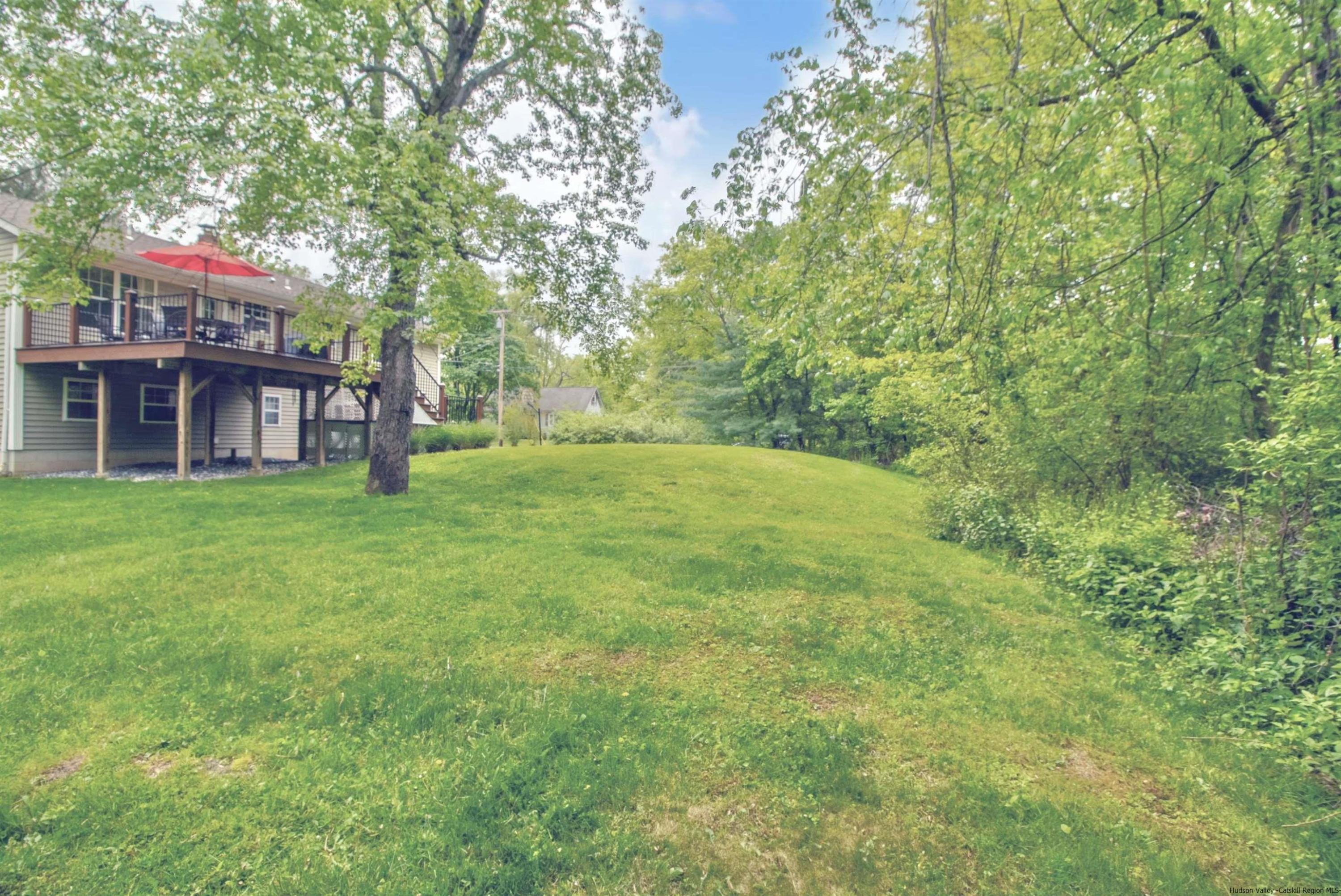 56 Alan Street Stone Ridge, NY 12484 - Photo 18 of 21 a view of a house with a big yard and large trees