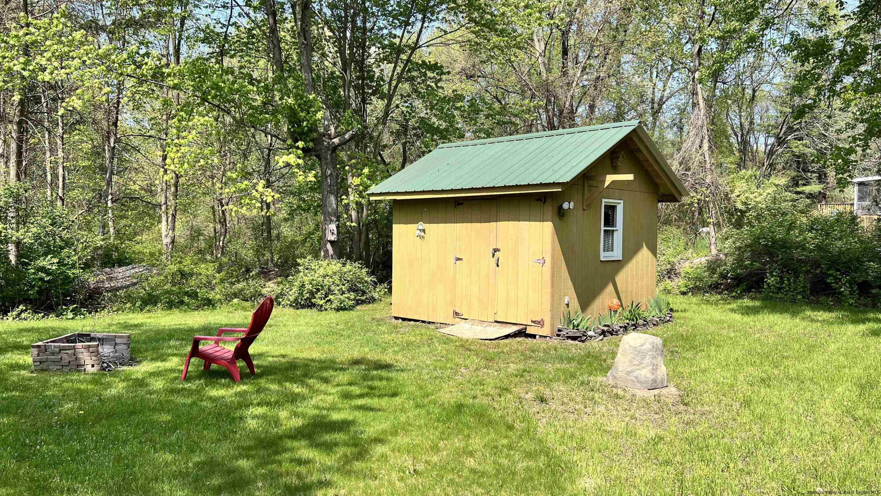 56 Alan Street Stone Ridge, NY 12484 - Photo 21 of 21 a view of a backyard with a small cabin