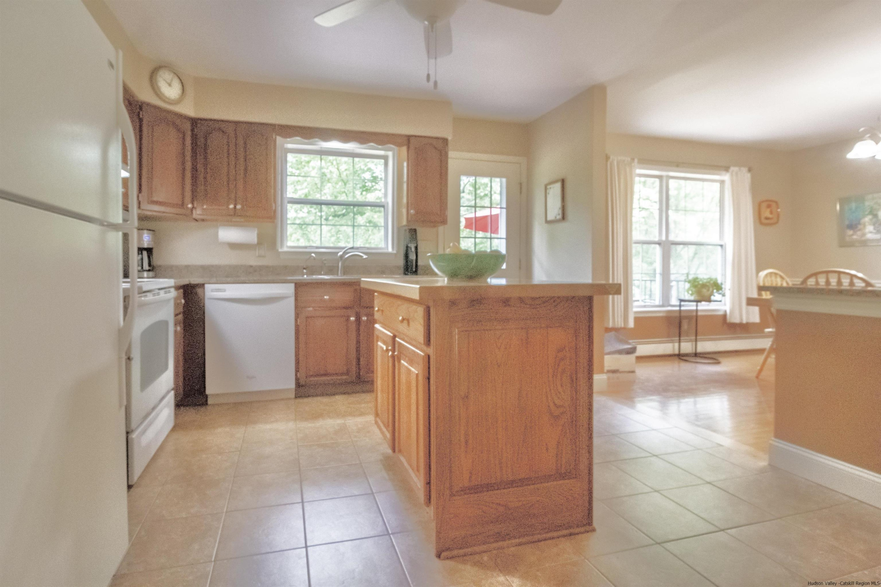 56 Alan Street Stone Ridge, NY 12484 - Photo 6 of 21 a kitchen with stainless steel appliances granite countertop a refrigerator and a stove top oven
