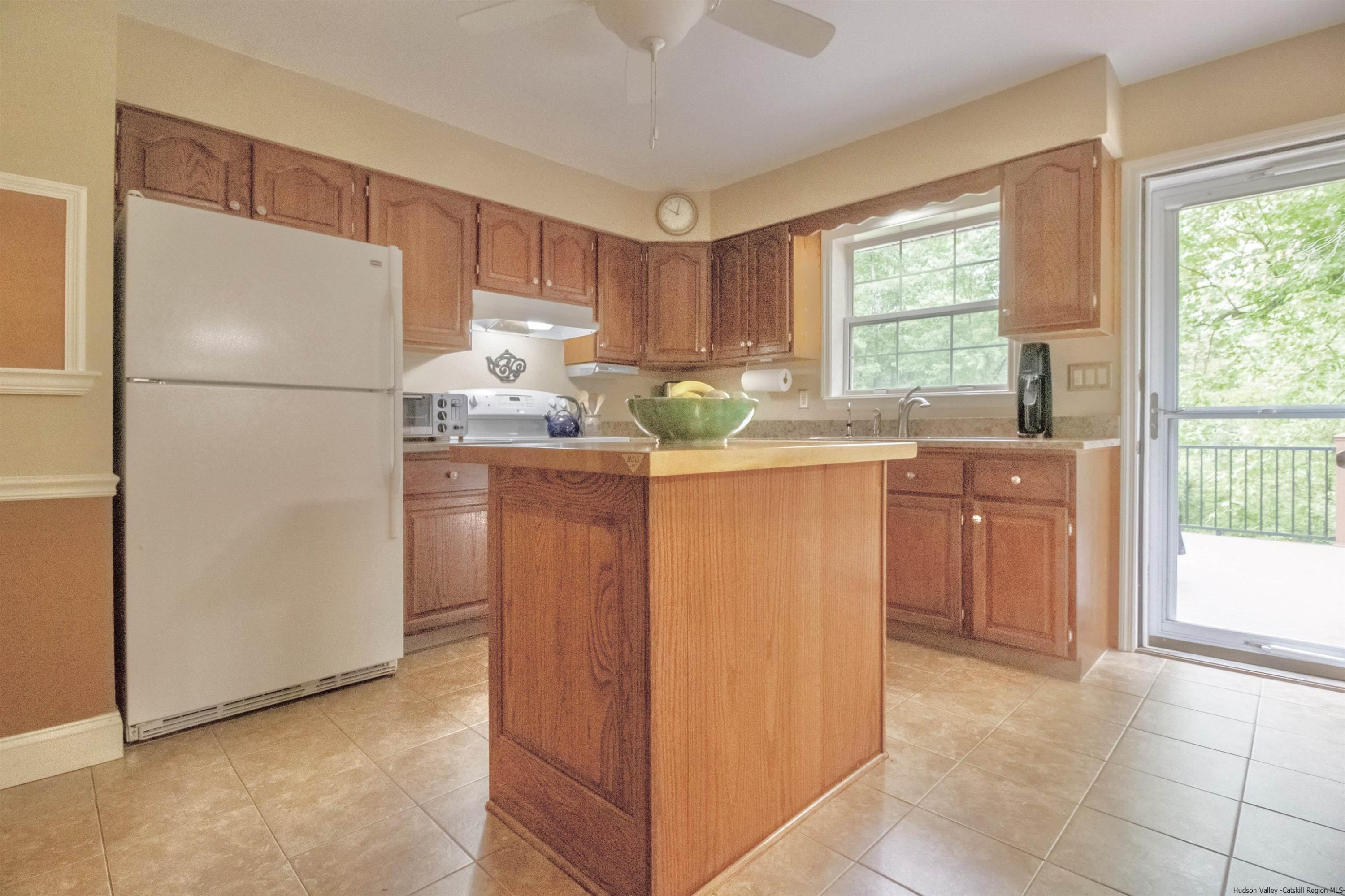 56 Alan Street Stone Ridge, NY 12484 - Photo 7 of 21 a kitchen with stainless steel appliances granite countertop a refrigerator and a sink
