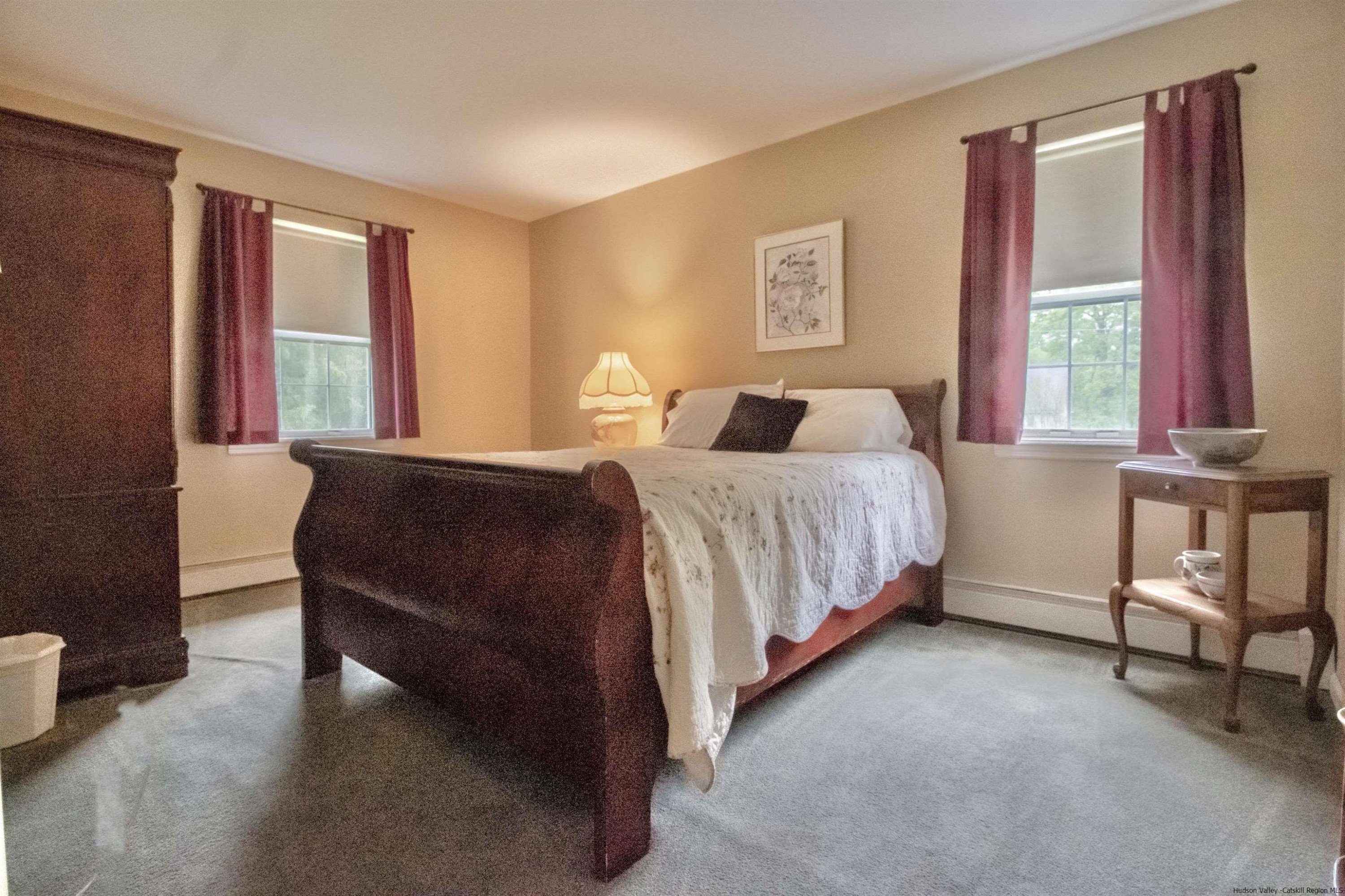 56 Alan Street Stone Ridge, NY 12484 - Photo 8 of 21 a bedroom with a bed and a couch next to a window