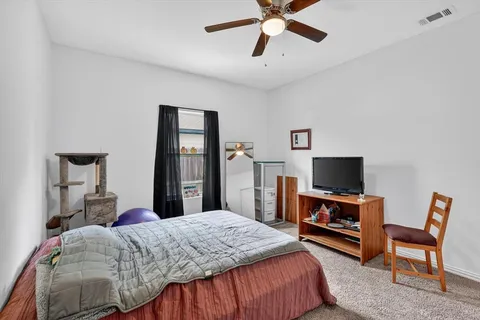 a bedroom with a bed and a flat screen tv