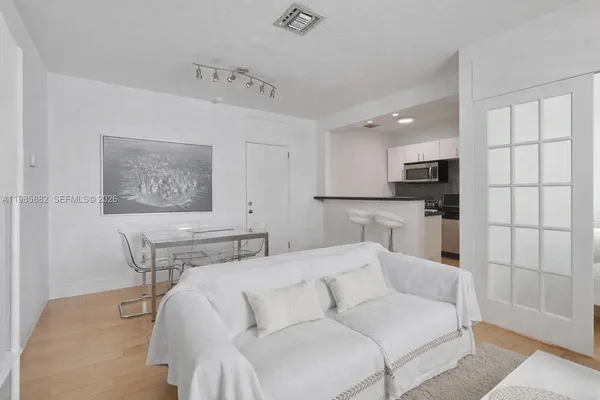 a living room with furniture and kitchen view