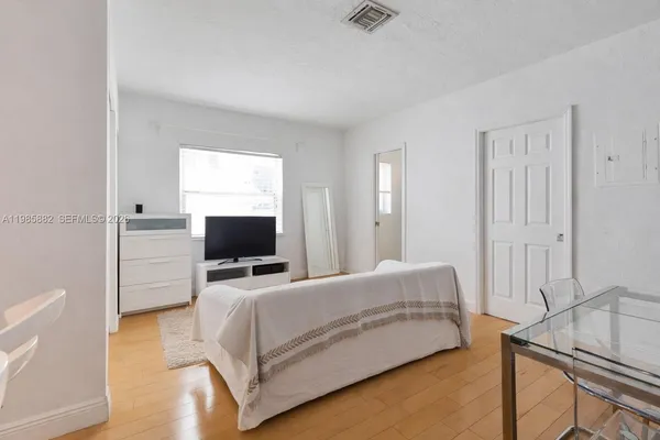 a bedroom with a bed and flat screen tv