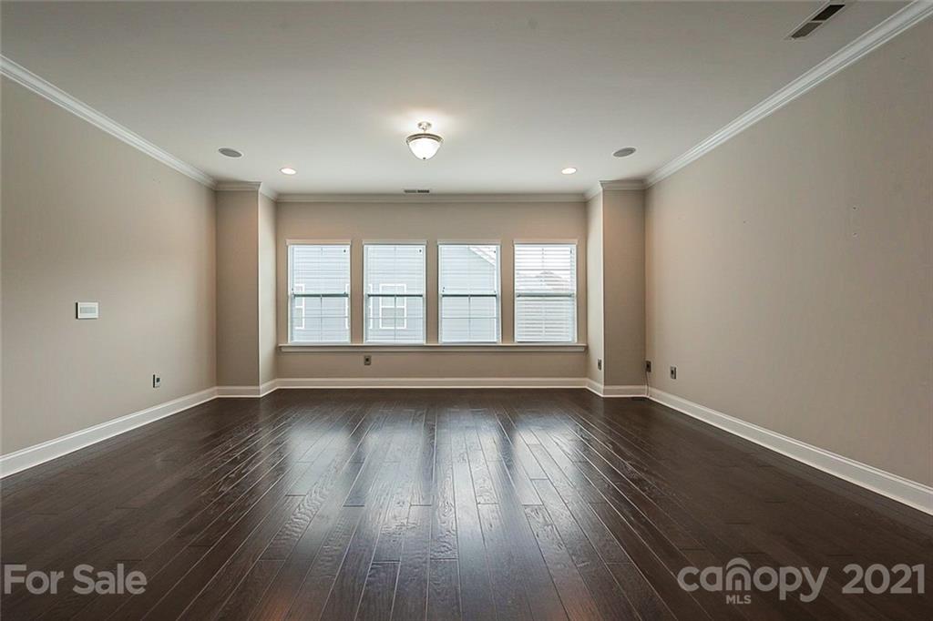 1021 Emory Lane Fort Mill, SC 29708 - Photo 14 of 24 an empty room with wooden floor and windows