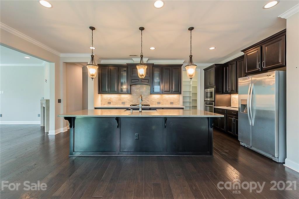 1021 Emory Lane Fort Mill, SC 29708 - Photo 4 of 24 a kitchen with stainless steel appliances granite countertop a refrigerator a sink and a stove