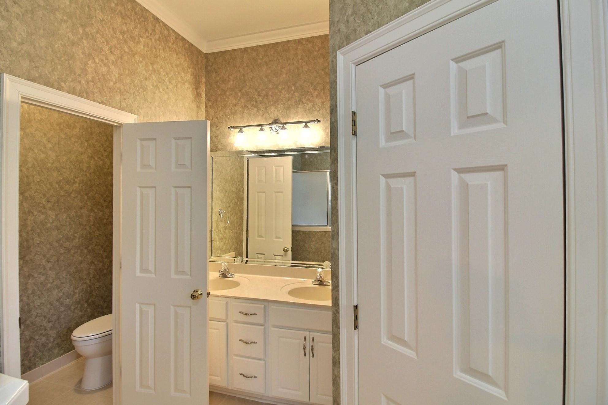 1748 Higginson Square Collierville, TN 38017 - Photo 15 of 23 a bathroom with a granite countertop sink a toilet and a shower