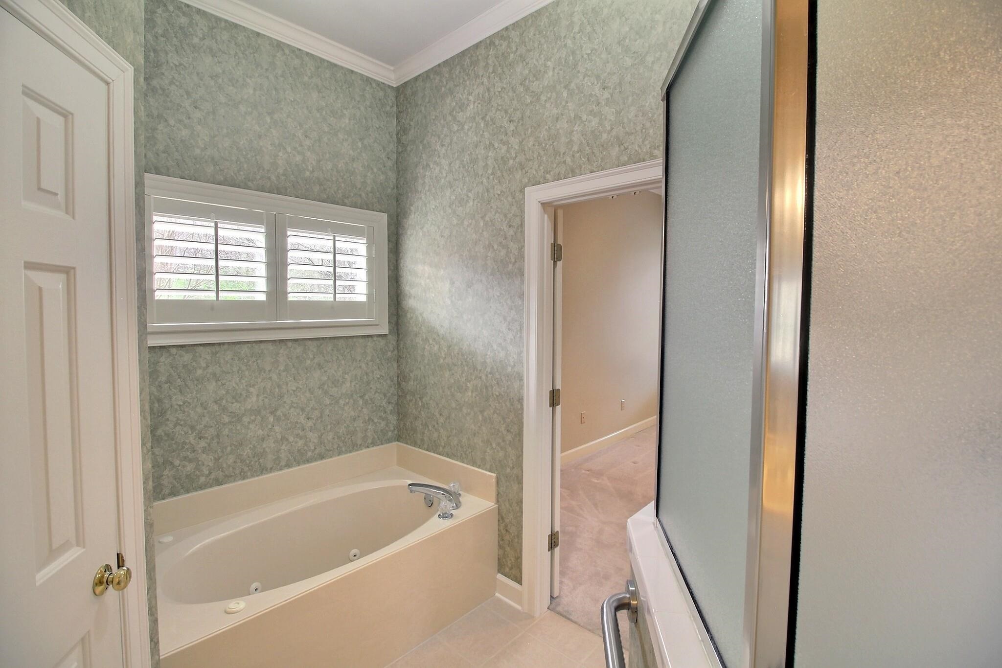 1748 Higginson Square Collierville, TN 38017 - Photo 16 of 23 a bathroom with a bathtub and a shower