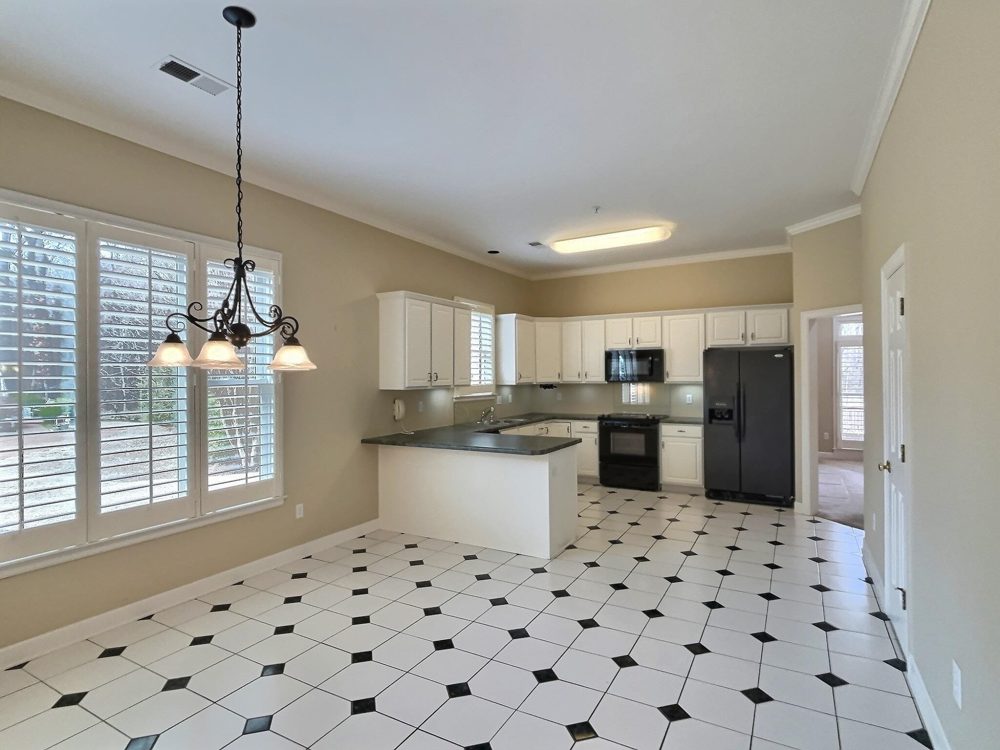 1748 Higginson Square Collierville, TN 38017 - Photo 6 of 23 a kitchen with a sink a counter top space and cabinets
