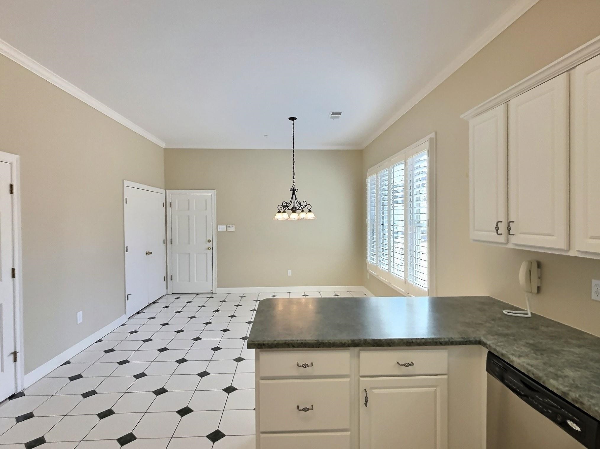 1748 Higginson Square Collierville, TN 38017 - Photo 8 of 23 a kitchen with granite countertop white cabinets and window