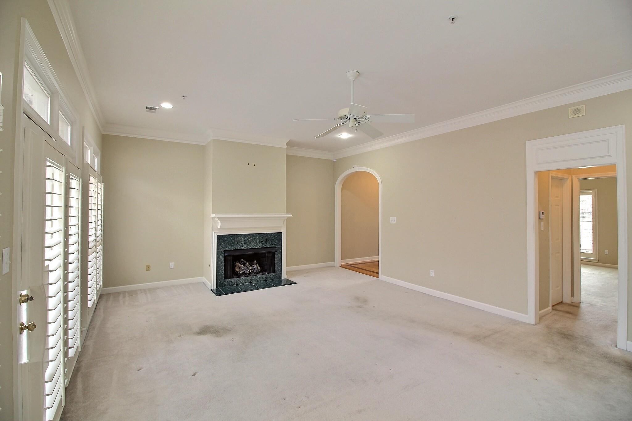 1748 Higginson Square Collierville, TN 38017 - Photo 9 of 23 a view of an empty room with a fireplace and a window