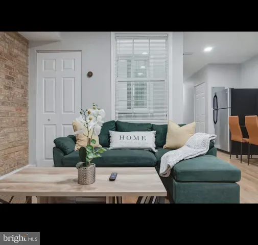 a living room with furniture and flowers