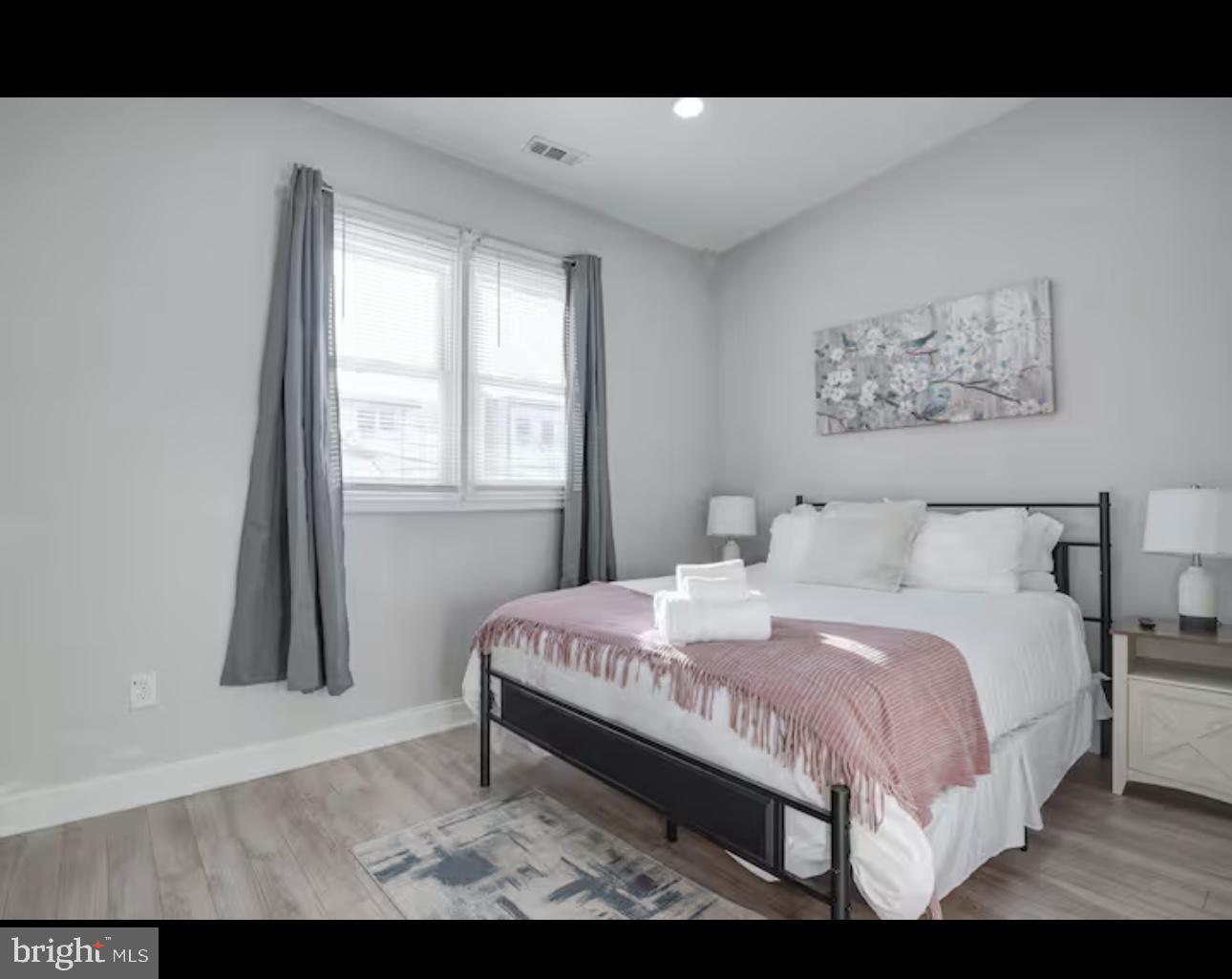 1255 Raum Street Northeast, Unit 1 Washington, DC 20002 - Photo 11 of 16 a bedroom with a bed and a window