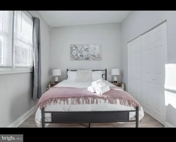 a bedroom with a bed and a large window