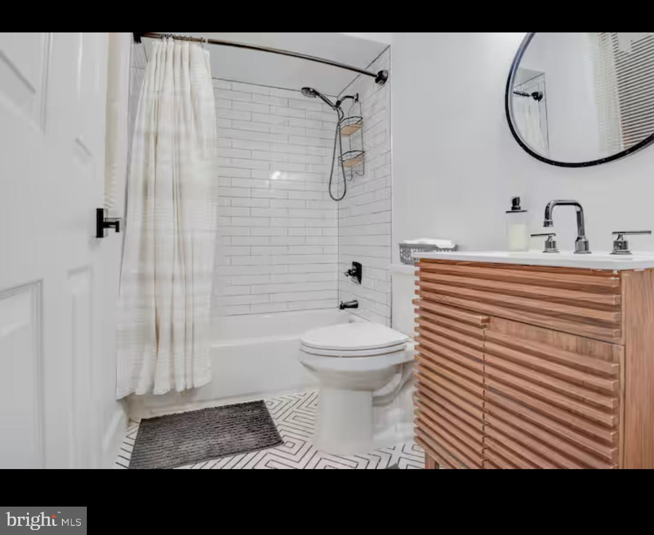 1255 Raum Street Northeast, Unit 1 Washington, DC 20002 - Photo 13 of 16 a bathroom with a sink a toilet and shower